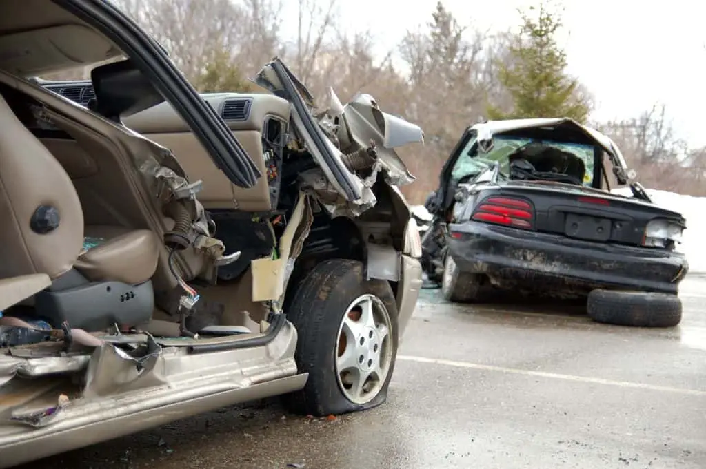 A car accident scene between a minivan and a sedan. Injured drivers and passengers were taken to the hospital. 