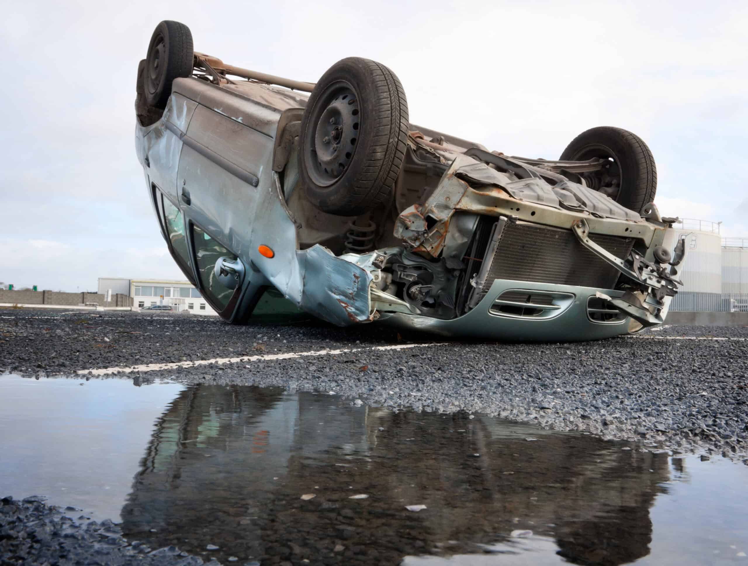 a car rolled over onto its hood after a rollover car accident.