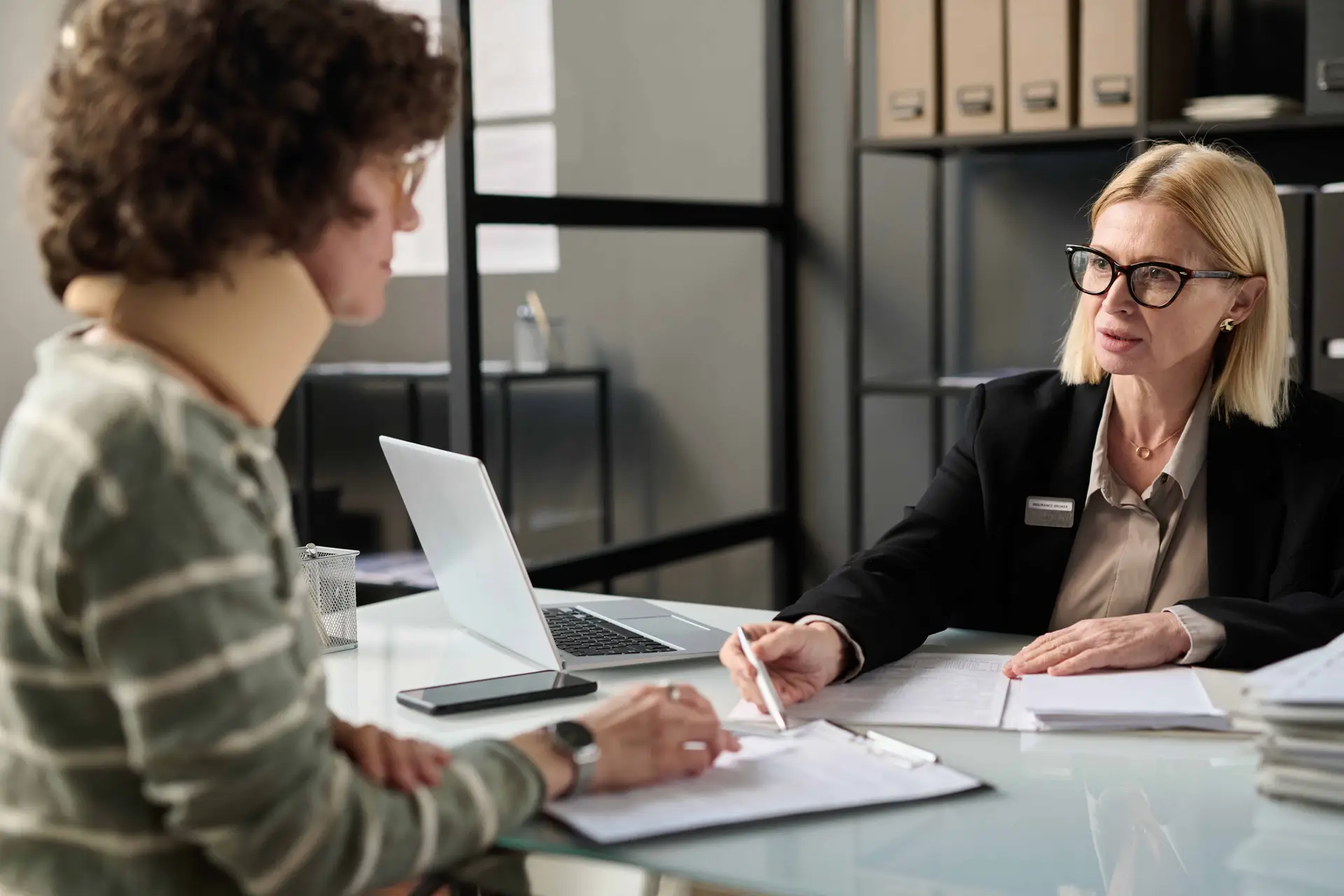 A personal injury lawyer discusses legal forms with one of her clients.