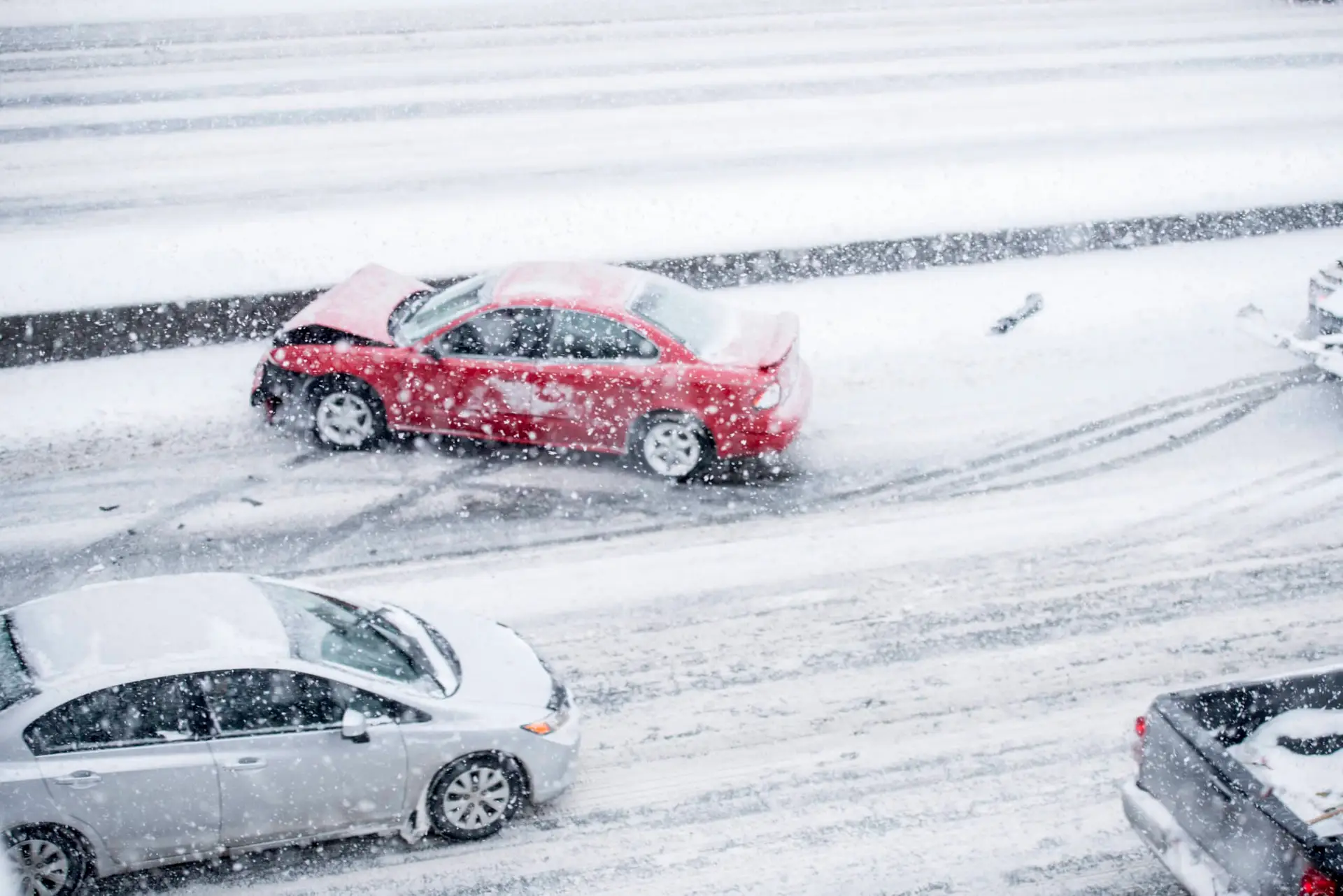 A car accident caused by snowy conditions and slick roads.