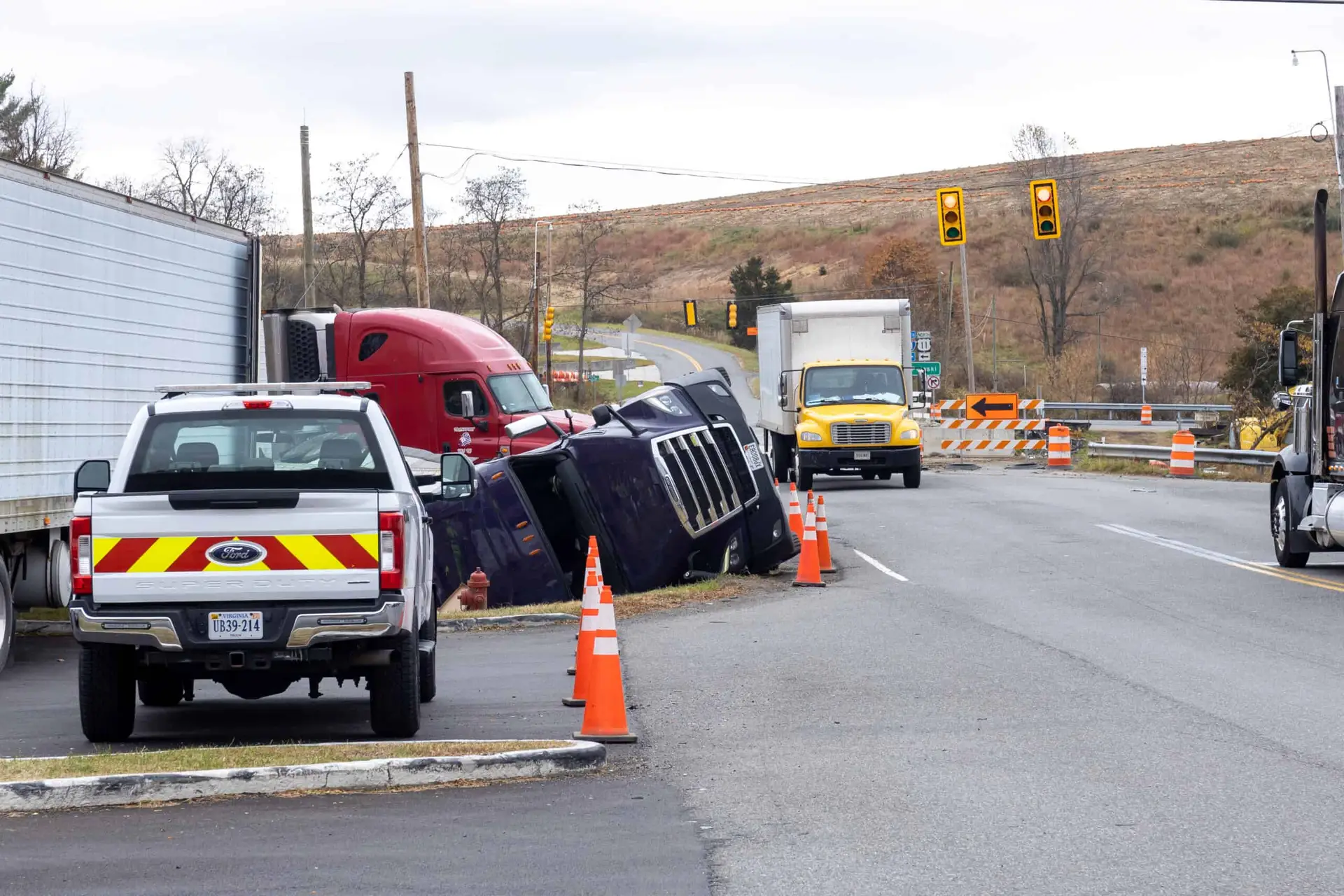 an overturned semi cab sits in the middle of the road after a truck accident with another semi-truck