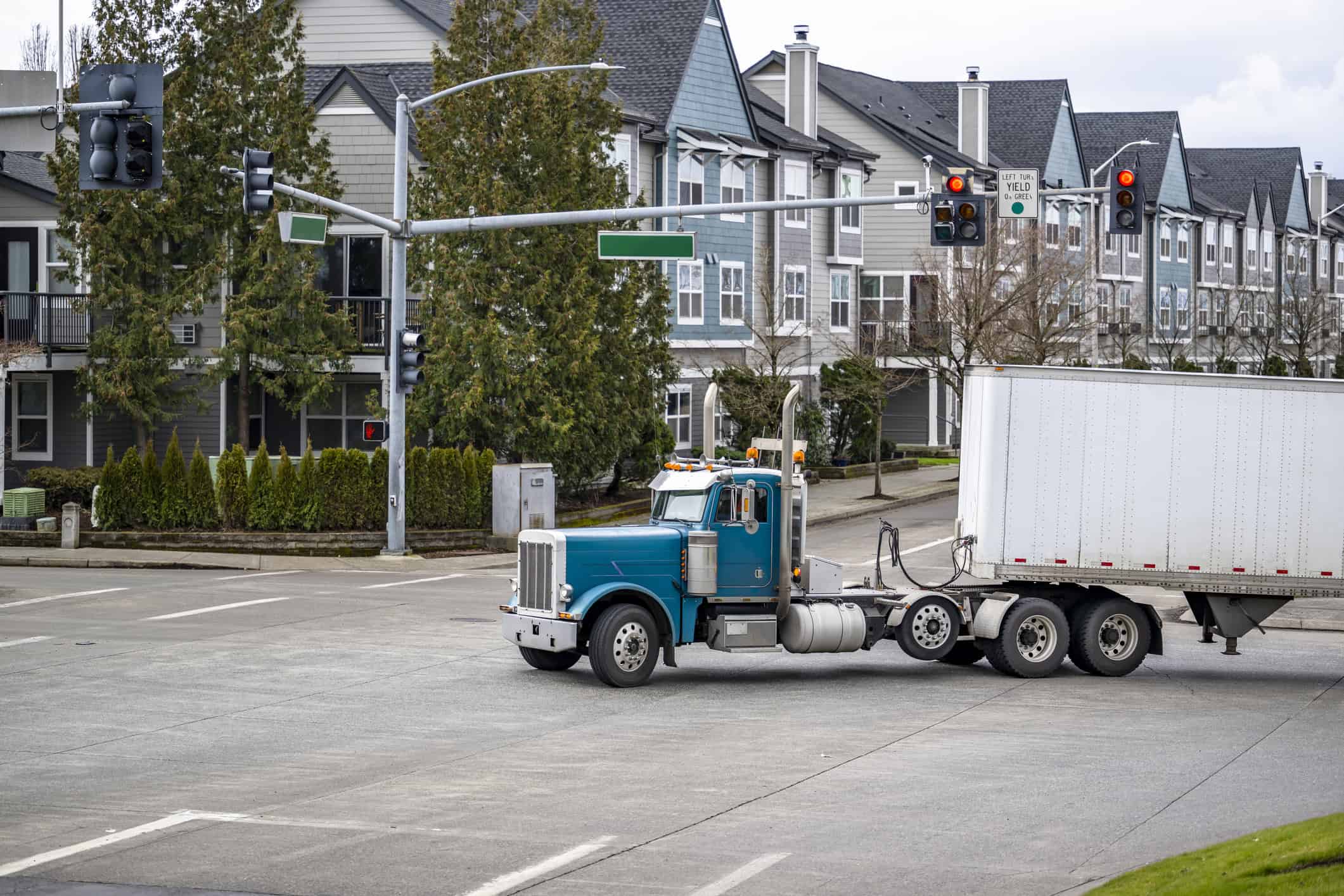 A semi-truck making a left-hand turn through an intersection.