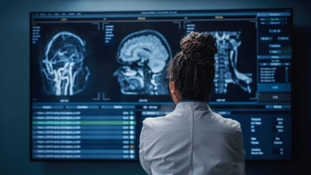 A doctor reviews images from a brain scan.