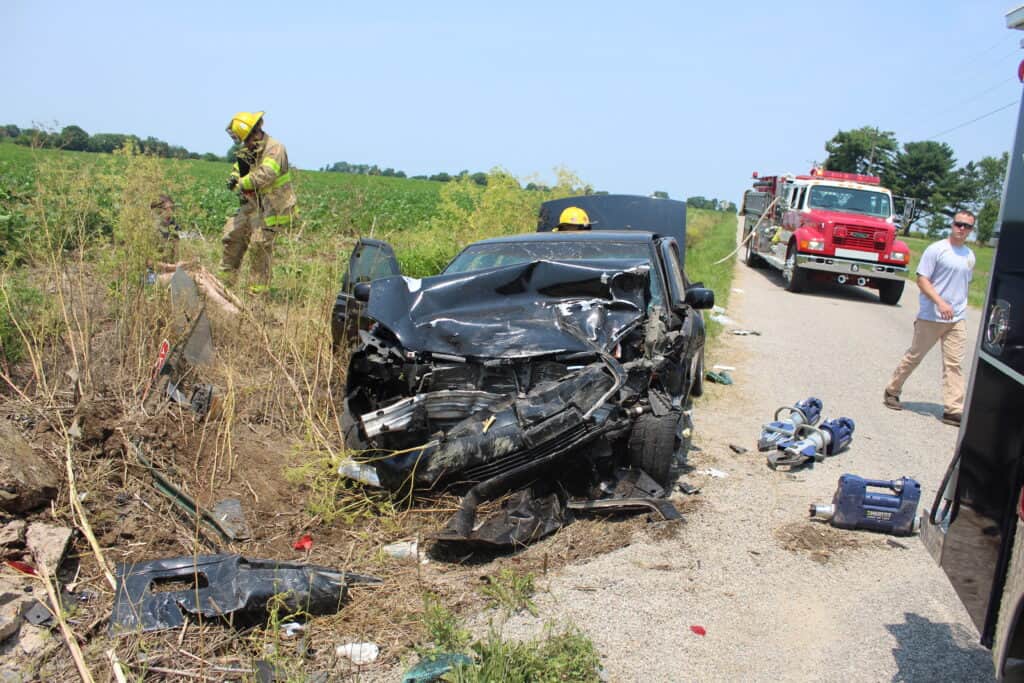 First responders at the scene of a car accident in rural Indiana that caused extensive damage to the vehicle involved and severe injuries to the passengers of the automobile.