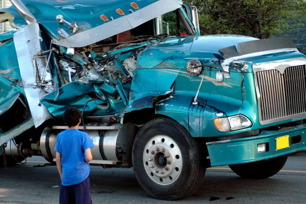 The damaged front end of a blue semi cab after a truck accident.