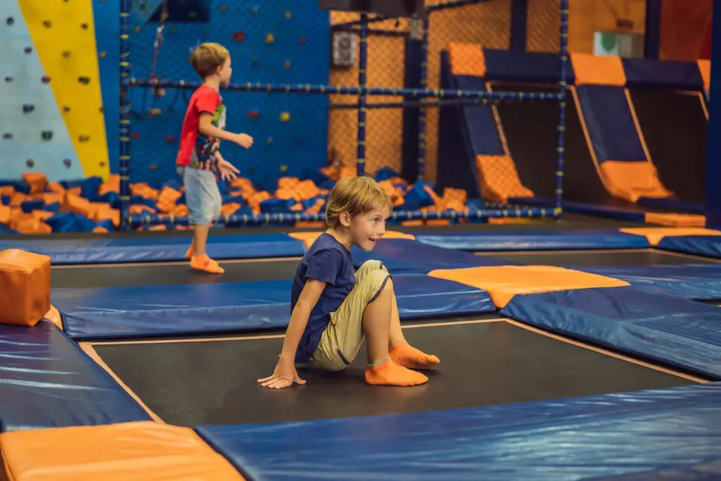 Young children at play in a trampoline park.